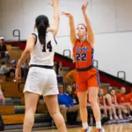 Vienna senior Abby Jones hits a 3pt basket contested by Johnston City's Marlie Roland Photo by Hunter Whitecotton/Southern Focus Photography