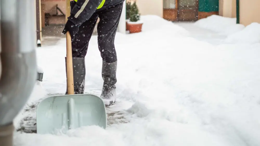 man-with-snow-shovel-cleans-sidewalk-royalty-free-image-1708642813815245