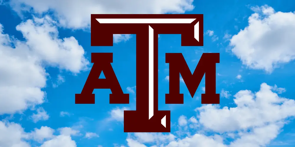 The Texas A&M logo against a cloudy sky background.