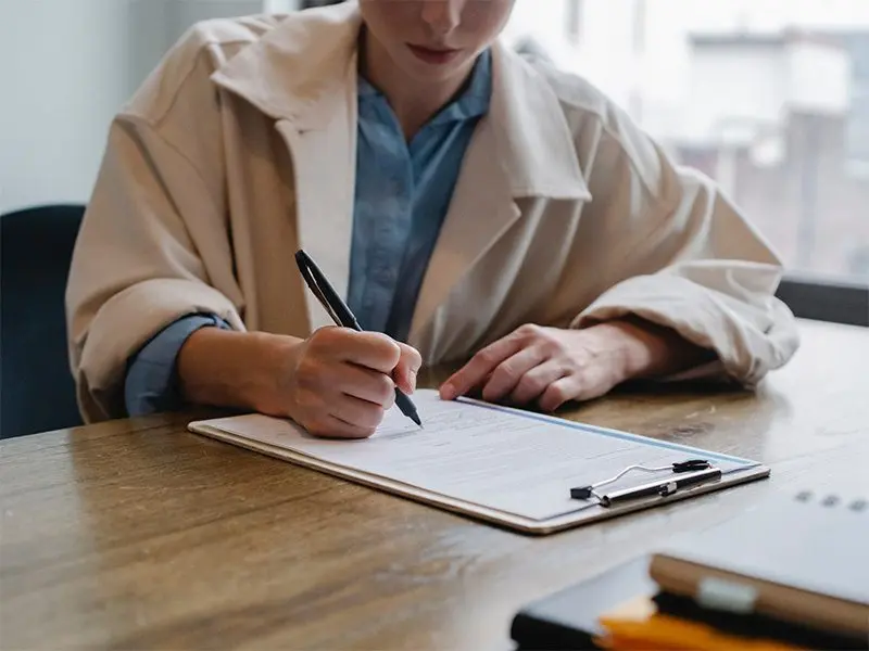 Young woman filling out a job application
