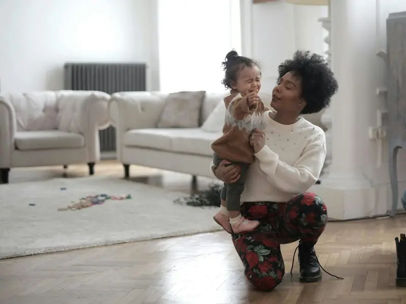 African American mother with her child in their living room