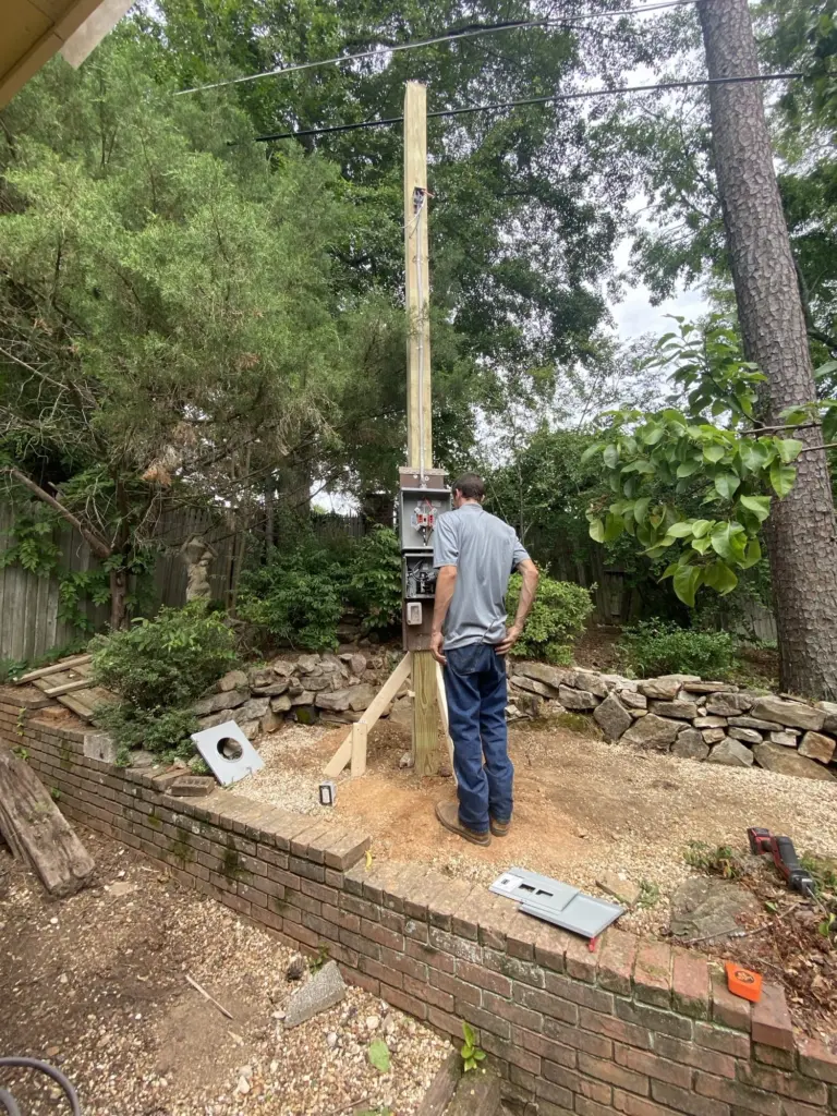 Brad, a technician working on an outdoor junction box