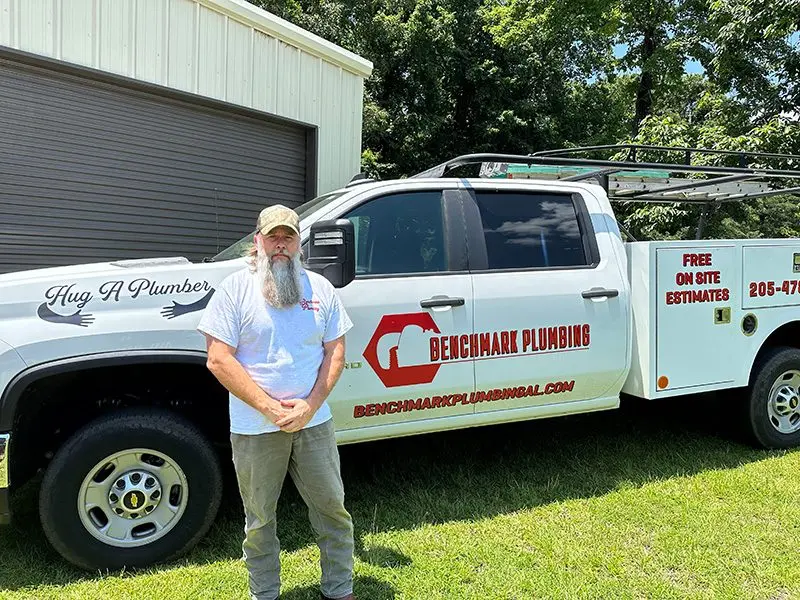 benchmark-plumbing-adam-ladu-in-front-of-his-truck