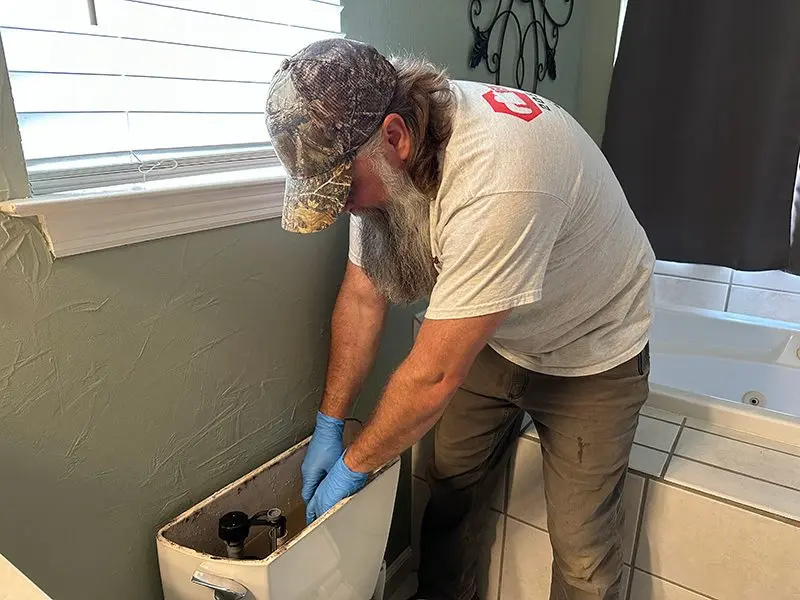 benchmark-plumbings-adam-ladu-repairing-a-toilet
