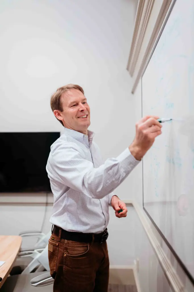 Paul Bryer at a whiteboard explaining the process