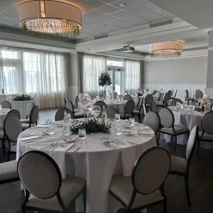 Neutral décor with white floor length linens are included in most packages