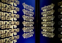 Official "Dancing With The Stars" logo multiplied and reflected by the tablet screen