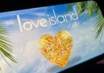 '2025 Love Island'' shown on a smart phone. is a reality dating show that originated in the UK. The premise involves a group of singles living together in a luxurious villa^ where they couple up Toronto^ Canada - June 5