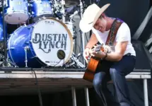 Dustin Lynch performs during the 'Kick The Dust Up' Tour at Vanderbilt Stadium on July 11^ 2015 in Nashville^ Tennessee.