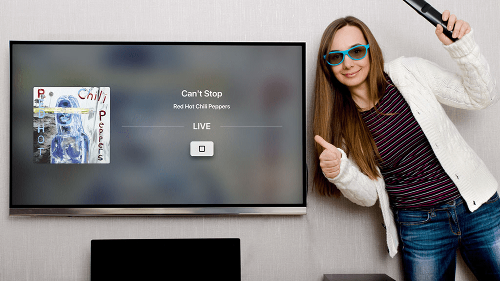 women giving thumbs up in front of tv app