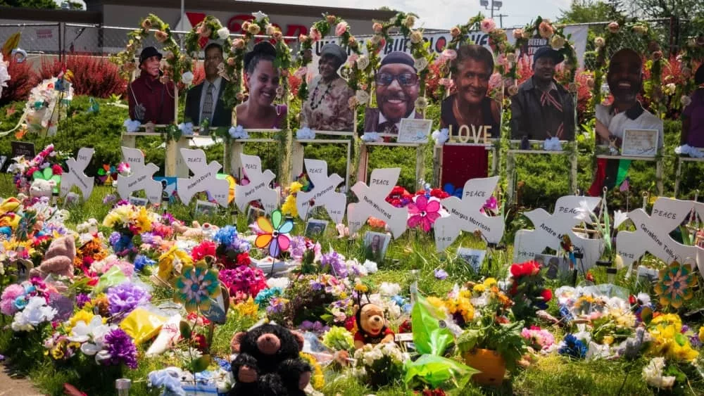 Memorial of flowers^ dove cut-outs and pictures of the African American victims of the mass shooting in Buffalo NY at a Tops supermarket. Buffalo^ New York^ USA- June 11^ 2022