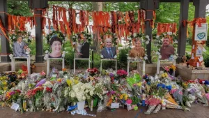Highland Park^ IL July 16^ 2022^ memorial to the High Park parade shooting victims with their photos and flower bouquets^ mass shooting