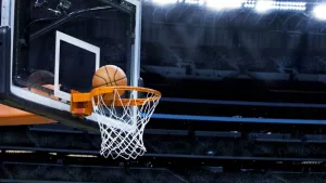 basketball going into hoop at arena (NBA)