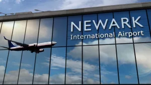 Aircraft landing at Newark^ New Jersey^ USA 3D rendering illustration. Arrival in the city with the glass airport terminal and reflection of jet plane. Travel^ business^ tourism and transport.