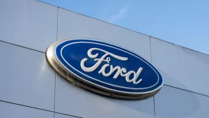 Closeup of the Ford logo seen at a Ford dealership store in Sunnyvale^ California. Ford Motor Company is an American multinational automobile manufacturer. Sunnyvale^ CA^ USA - Nov 22^ 2023
