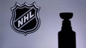 National Hockey LeagueLogo of NHL club on the screen. Stenley Cup Trophy Silhouette.