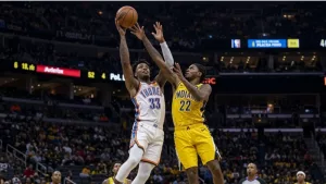Realistic photography of two basketball players fighting in the air to catch the ball falling after a failed shot in an nba game. one basketball player is from the oklahoma city thunder and the other basketball player is from the indiana pacers. the photo