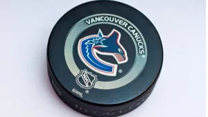 Official Vancouver Canucks game puck on the ice ^product shot