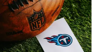 Tennessee Titans NFL team Logo and American football ball on Green Grass. TENNESSEE^ USA^ FEBRUARY 10^ 2025