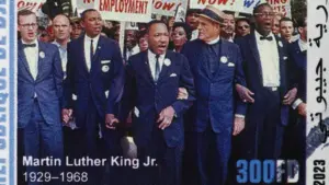 Martin Luther King during a protest march on postage stamp Milan^ Italy – January 7^ 2024
