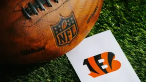 Cincinnati Bengals NFL team Logo and American football ball on Green Grass. CINCINNATI^ USA^ FEBRUARY 10^ 2025