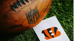 Cincinnati Bengals NFL team Logo and American football ball on Green Grass. CINCINNATI^ USA^ FEBRUARY 10^ 2025