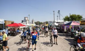 RAGBRAI cyclists arrive in Alexander, Iowa. (Photo: Iowa Soybean Association / Joclyn Kuboushek)