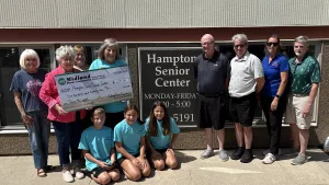 Hampton Senior Center staff and volunteers accept a donation from Midland Power Coop. Also in attendance were officials from the Chamber/Main Street Program.