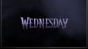 TV on black wall. TV screen playing Netflix series 'Wednesday' trailer