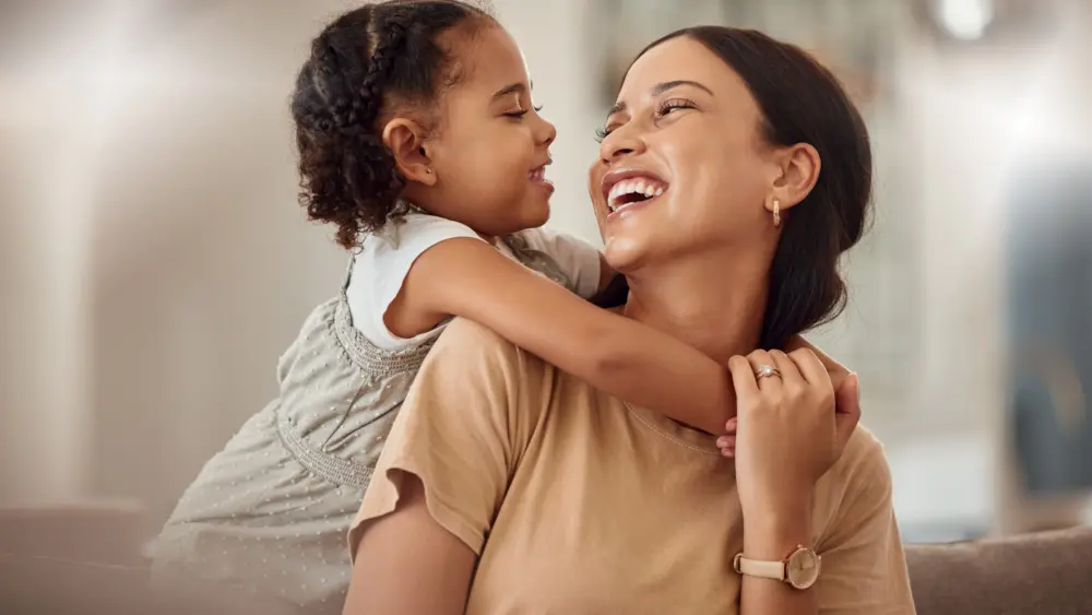 happy-mama-with-girl-child-hug-in-home-and-weekend-play-time-lifestyle-for-mom-parent-funny-crazy-kid-in-living-room-mother-holding-toddler-with-smile-and-love-bonding-together-on-mothers-day-2