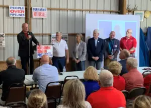 Rep. Holt introduced fellow Republicans who voted for House File 639 to a crowd in Shelby County on Sunday, Oct. 6, 2025. (Radio Iowa photo)