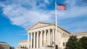 Facade of the United States Suprement Court with American flag in Washington^ DC