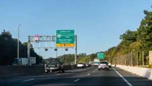 Highway i-95 interstate road in Virginia with cars on commute in morning traffic near Washington DC and sign for Prince William Parkway and ManassasWoodbridge^ USA - October 18^ 2021:
