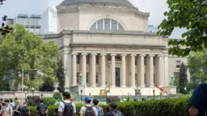 Students at the Columbia University campus on the Upper West Side of Manhattan. Steps of the Low Memorial Library in the background. New York^ NY^ USA - July 8^ 2022: