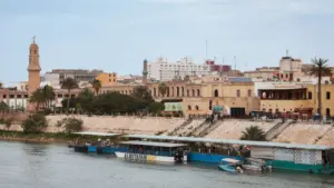 Historic buildings and riverboats on the Tigris River in Baghdad^ Iraq Baghdad^ Iraq - March 22^ 2025