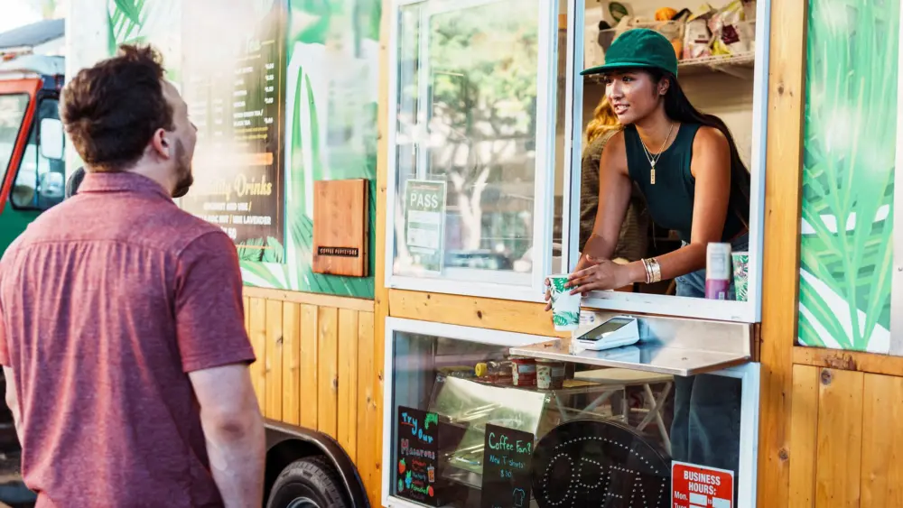 male-customers-smiles-while-receiving-drink-from-barista