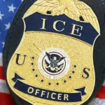 US ICE Officer badge on United States of America flag close up