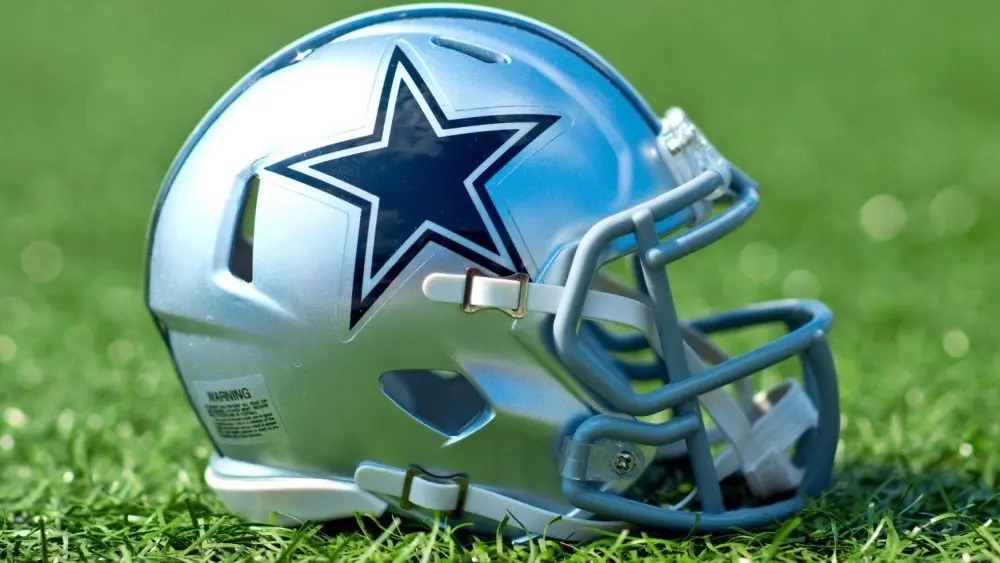 NFL Dallas Cowboys helmet on artificial grass playing turf ^ product shot