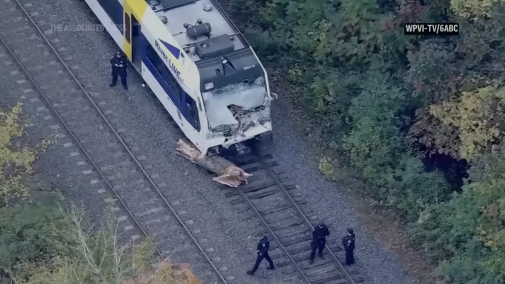 Operator dies, passengers injured as New Jersey commuter train hits a piece of a tree