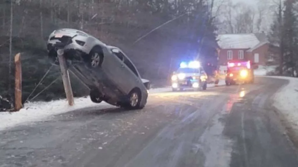How did that happen?! Car gets stuck on top of broken utility pole in Maine
