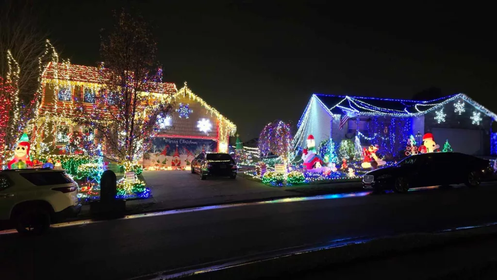Man decorates his home and his neighbor's house for Christmas