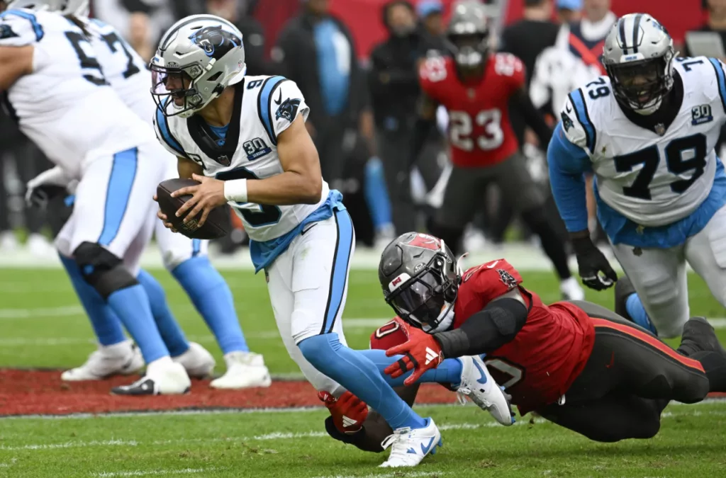 Mayfield throws 5 TD passes and Bucs keep playoff, NFC South hopes alive with 48-14 rout of Panthers