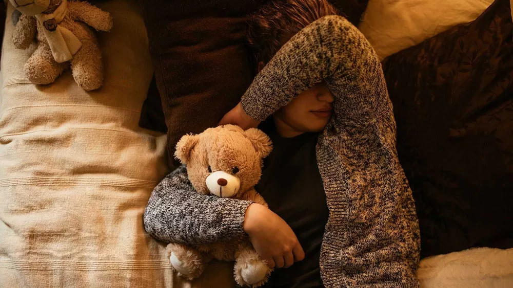 Adults can sleep with stuffed animals, too. It might even be a good thing, experts say