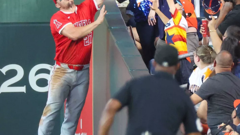Fan controversially rips ball from Mike Trout's glove