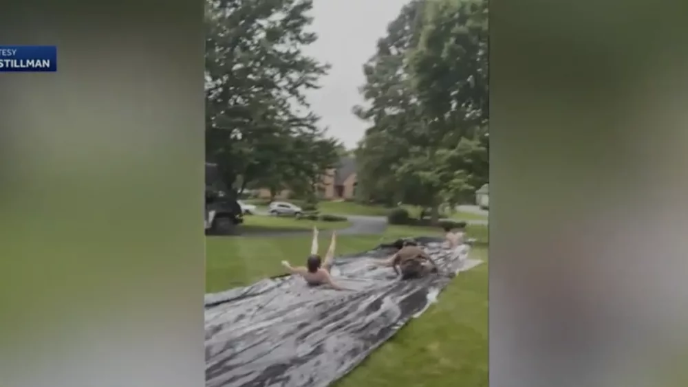 VIDEO: UPS driver cools off on slip-and-slide after delivering package