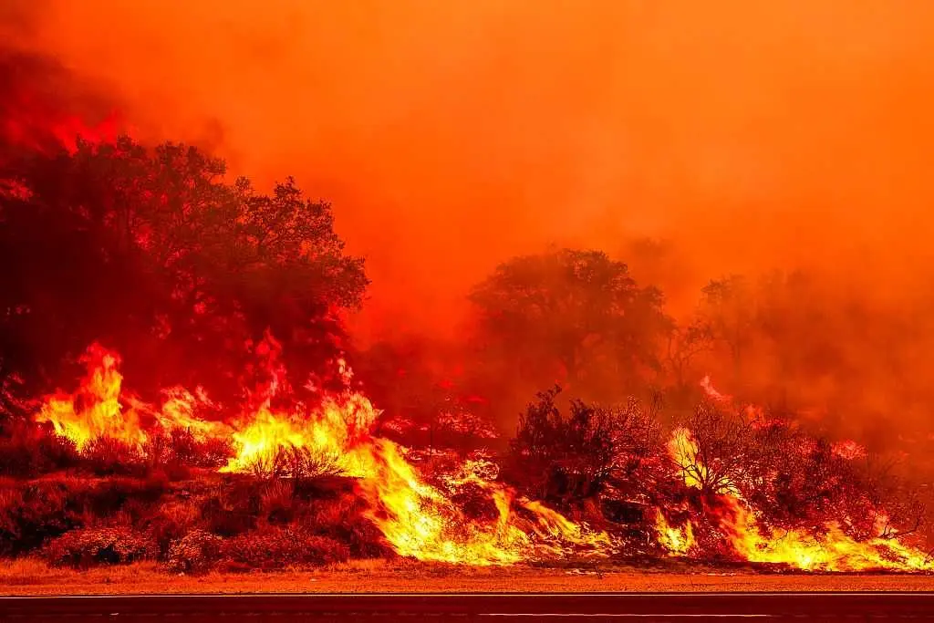 Massive wildfire in California threatens homes, injures 3 people