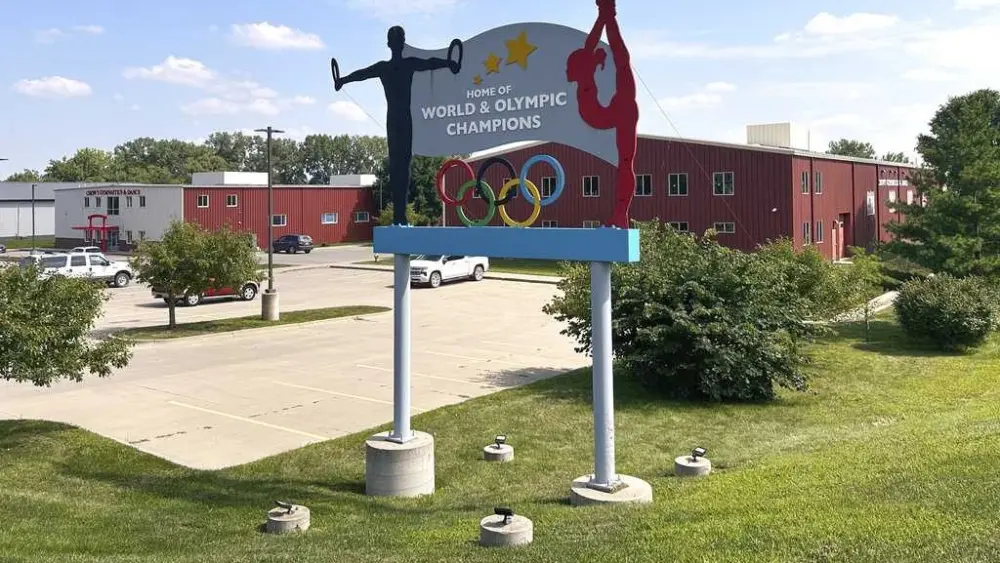 Years after abuse reports, ex-coach at renowned US gymnastics academy is arrested by FBI
