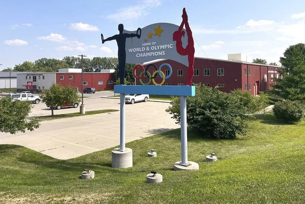 Years after abuse reports, ex-coach at renowned US gymnastics academy is arrested by FBI