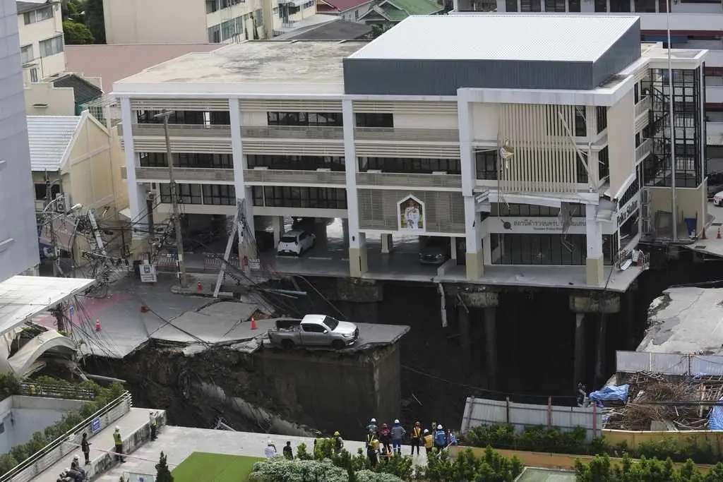 Bangkok sinkhole swallows road near police station as officials race to prevent further damage