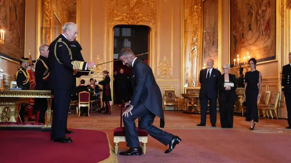 Bend a knee like Beckham: Soccer star is knighted by King Charles III